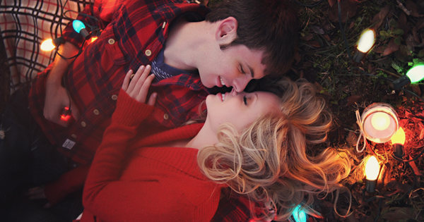 A beautiful landscape photo with mountains, a clear sky and a serene lake, surrounded by lush green trees.